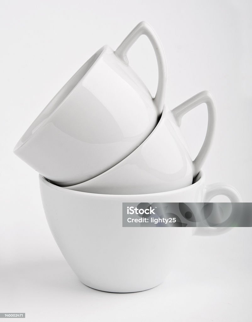 White cups on gray background Ceramics Stock Photo