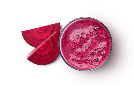Glass of beetroot smoothie juice with beet root sliced isolated on white background. Top view. Flat lay.