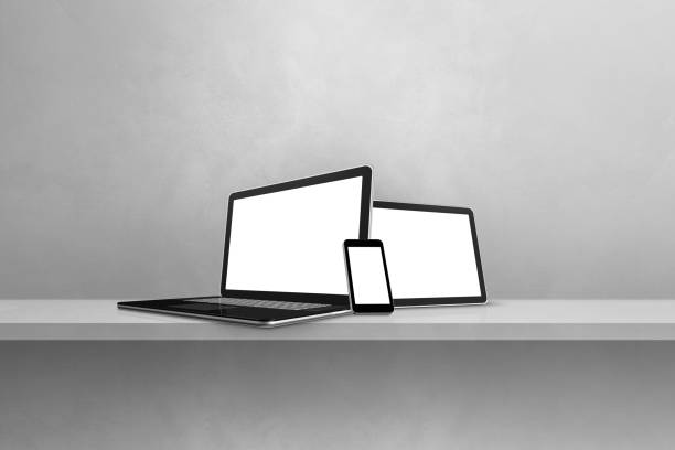 istock Laptop, mobile phone and digital tablet pc on grey wall shelf. Horizontal background 1400026431