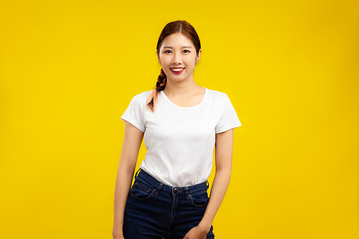 Photo of Asian Woman over isolated yellow background, fashion and lifestyle summer concept