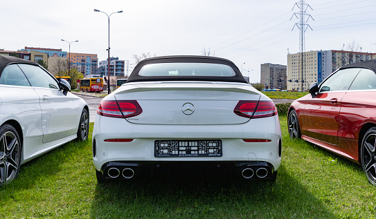 Łódź, Poland - May 1, 2022: A rear view picture of a white Mercedes Benz Class C Cabrio at a car dealership.