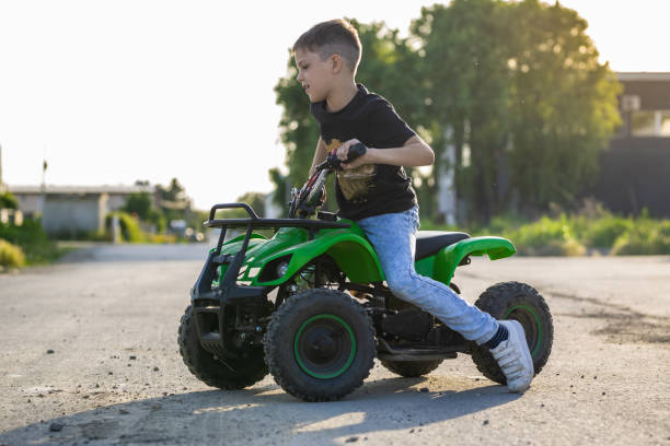 istock Boy riding green quad motor 1400032236