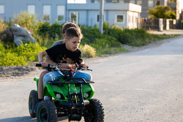 istock Kids having a great time riding quad motor 1400032308