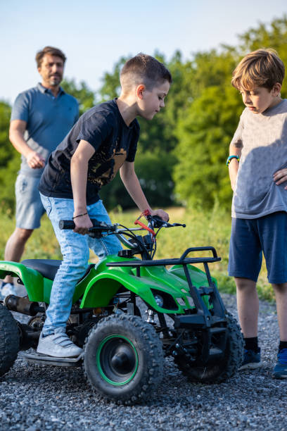 istock Kids riding ATV motor 1400032436