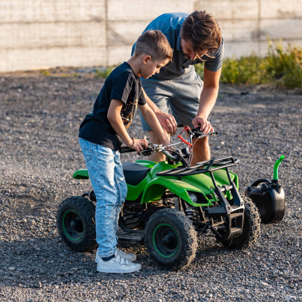 istock Father and son refueling quad bike 1400032665