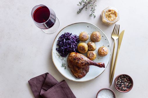 Baked duck leg with potatoes and red cabbage