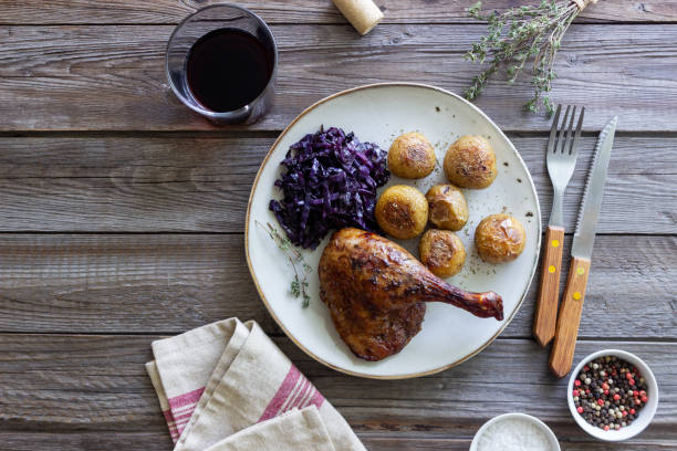 istock Baked duck leg with potatoes and red cabbage. 1400032742
