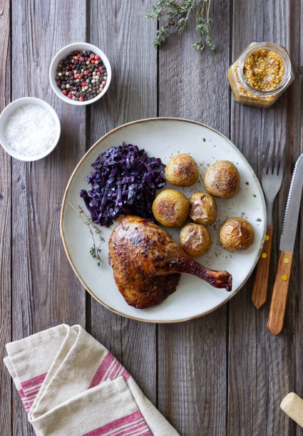 istock Baked duck leg with potatoes and red cabbage. 1400032762