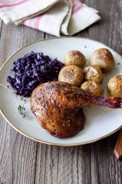 istock Baked duck leg with potatoes and red cabbage. 1400032792