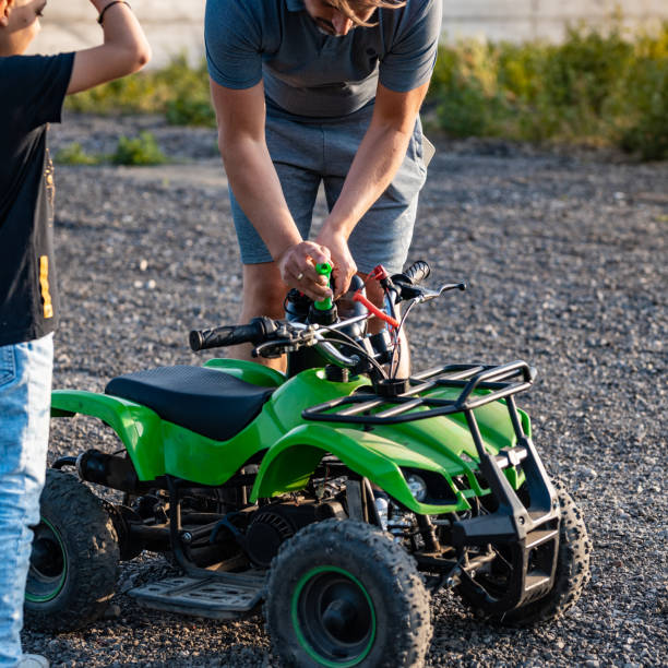 istock Father refueling kids quad 1400033560