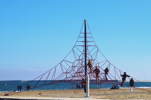 Valencia, Spain. 02 16 2019. Children playing on a rope playground on a sunny winter day.