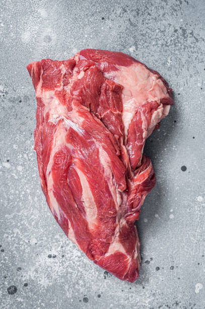 istock Boneless Raw lamb neck meat on a butcher table. Gray background. Top view 1400038521