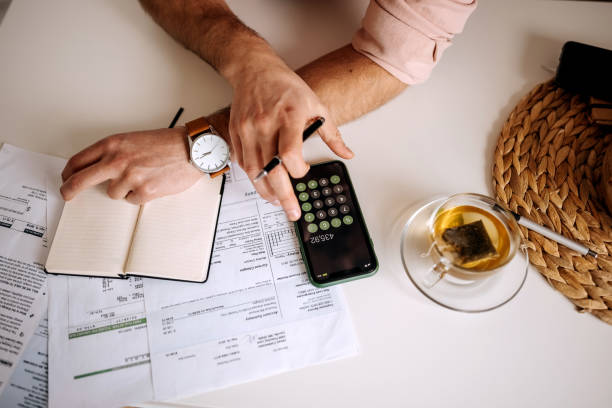 istock Unrecognisable man using calculator on the phone to calculate expenses 1400042568