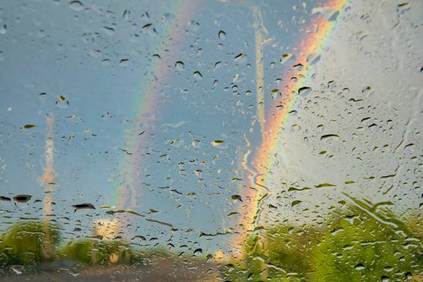istock Raindrops and rainbow on the car wind glass. 1400043156