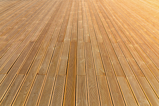 Natural wooden flooring, larch planks perspective view, background photo with selective focus