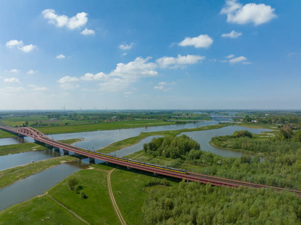 istock Train driving over the Hanzeboog train bridge over the river IJssel 1400043322
