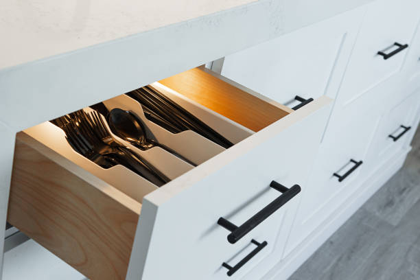 Inside of lit up silverware drawer stock photo