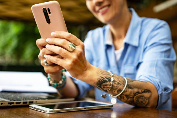 istock Unrecognizable businesswoman using phone 1400044654