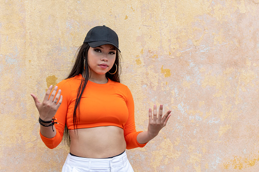 Funky young latin woman hip hop dancing in the street, Panama - stock photo