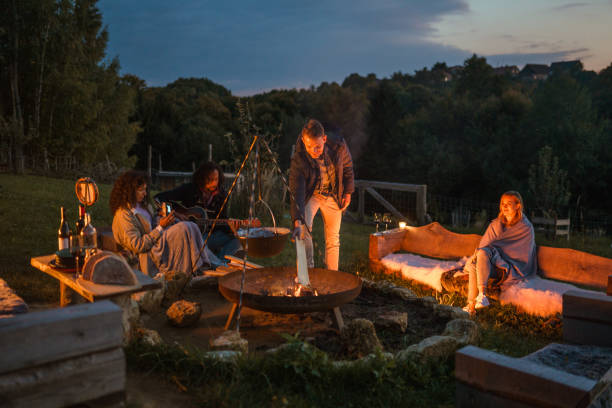 istock Mixed Race Friends Camping Together In Nature 1400047734