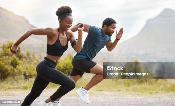Fit African American Couple Running Outdoors While Exercising Young Athletic Man And Woman Training To Improve Their Cardio And Endurance For A Healthy Lifestyle They Love To Workout Together Stock Photo - Download Image Now