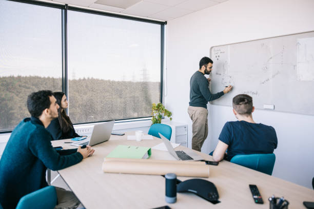 istock Businessman presenting his idea to colleagues 1400051416