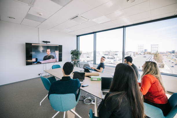 istock Group of colleagues making a video call 1400051464