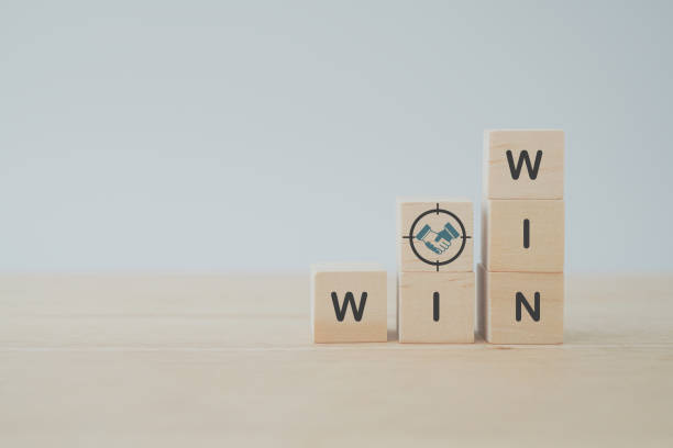 handshake icon in focus sign and win win text  on wooden cube blocks with , inspirational business and win ideas. Collaboration concept stock photo