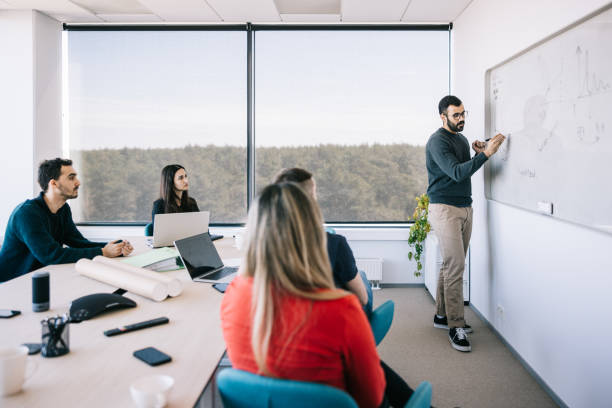 istock Businessman presenting his idea to colleagues 1400051535