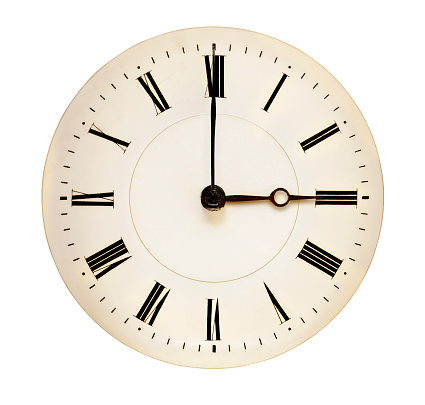 Antique clock face pointing at three o'clock isolated against white background