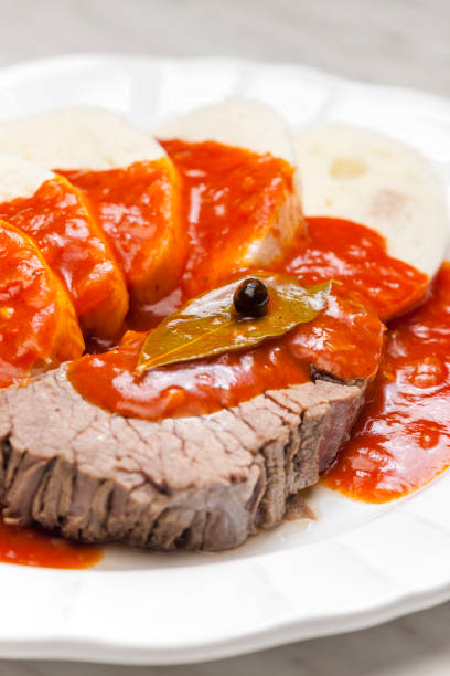 beef meat with tomato sauce and dumplings