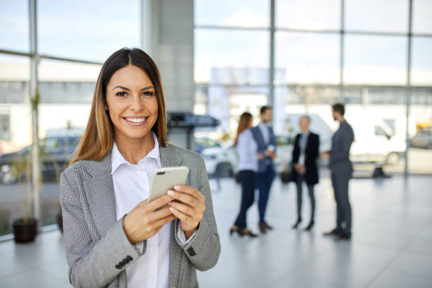 istock Young businesswoman using mobile phone and text messaging 1400052163