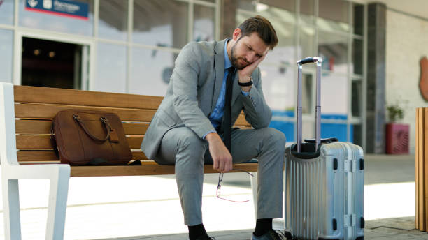 istock Pensive businessman is waiting at train station alone 1400053280