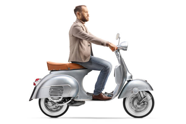 istock Young man riding a vintage scooter bike to work 1400054499