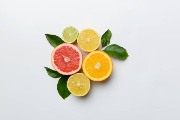 istock Fruit background. Colorful fresh fruits on colored table. Orange, lemon, grapefruit Space for text healthy concept. Flat lay, top view, copy space 1400054861