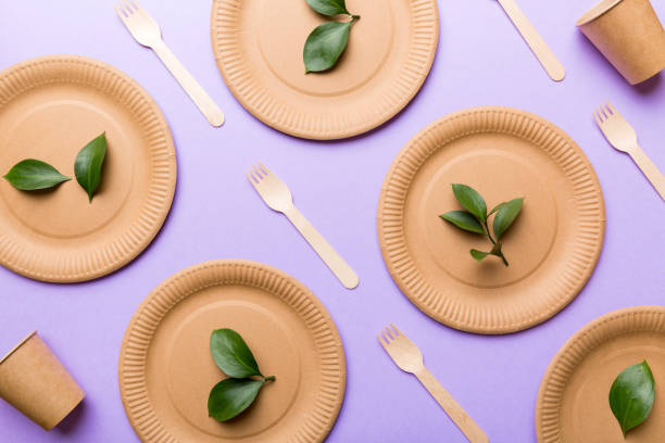 istock set of empty reusable disposable eco-friendly plates, cups, utensils on light white colored table background. top view. Biodegradable craft dishes. Recycling concept. Close-up 1400054871