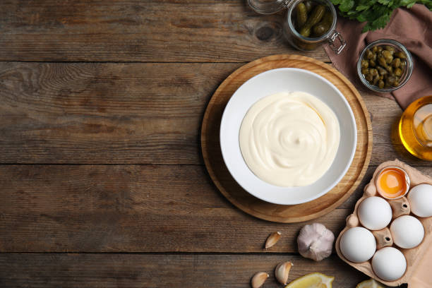 istock Flat lay composition with tartar sauce ingredients on wooden table, space for text 1400056443