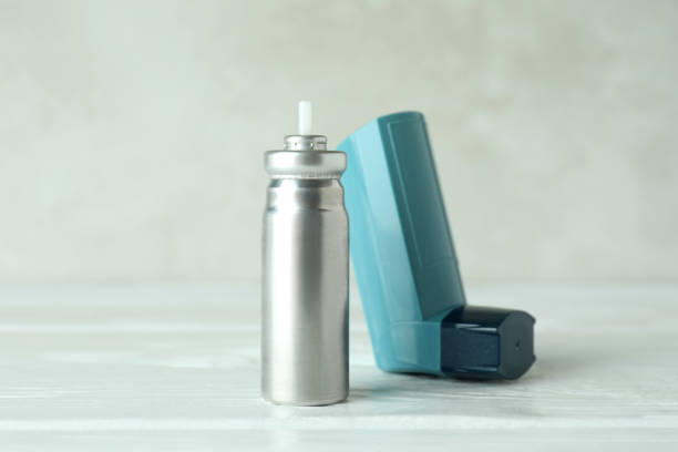 istock Blue asthma inhaler on white wooden table 1400058316