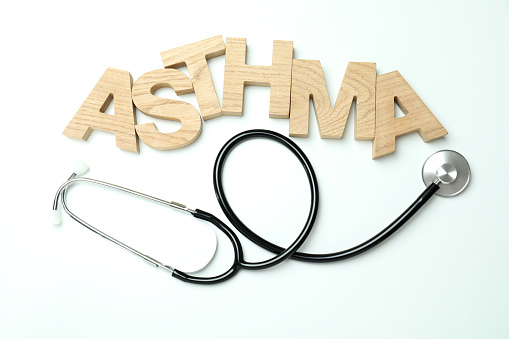 Word Asthma made of wooden letters and stethoscope on white background