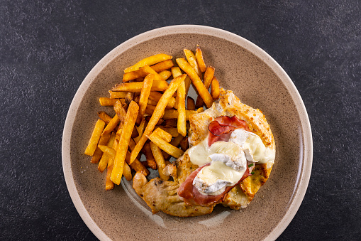 typical czech cuisine chicken slice baked with ham and camembert with french fries
