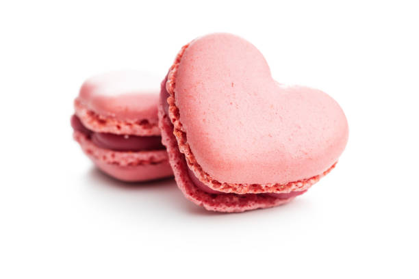 istock Heart shaped Sweet macarons isolated on white background. 1400059689