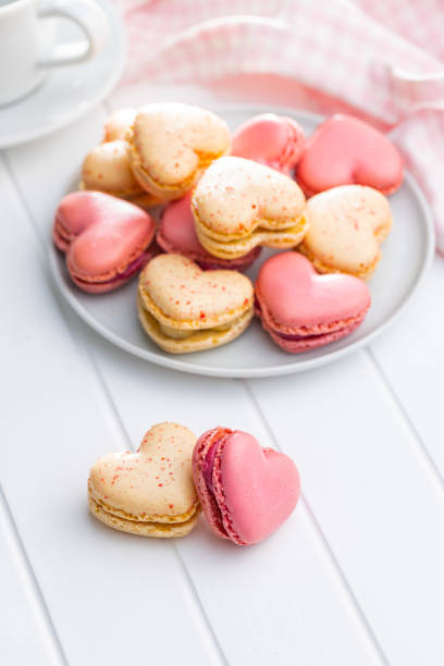 istock Heart shaped Sweet macarons on white table. 1400060374