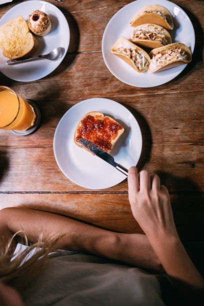 Above shot of a piece of bread with jam on a plate.