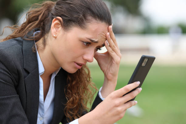 istock Worried executive checking bad news on cell phone 1400061204