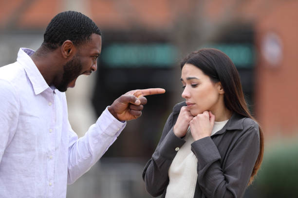 istock Angry man scolding and accusing to a scared woman 1400061718