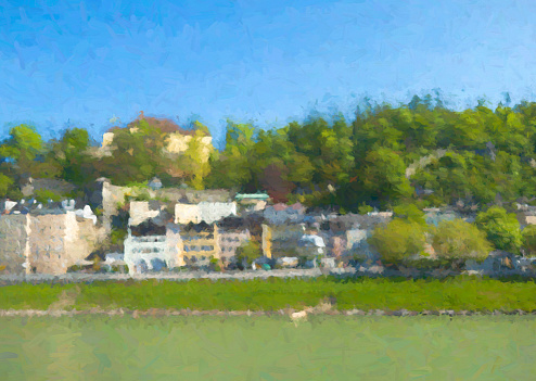The river Salzach in Salzburg, Austria on a bright spring morning. The houses on the east bank of the river are reflected in the water. Post processed to give a painterly effect.