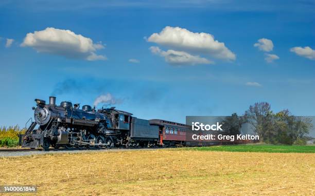 View Of An Antique Steam Train Locomotive Approaching Thru Trees Stock Photo - Download Image Now