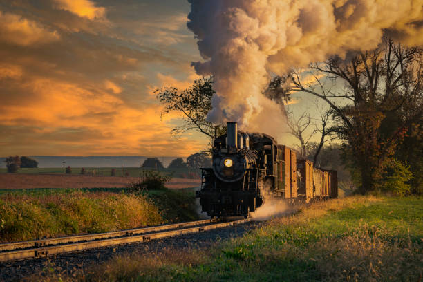 istock View of an Antique Freight Steam Train Blowing Smoke Approaching Thru Trees 1400061964