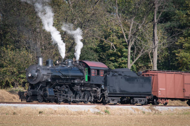 istock Antique Steam Freight Train Approaching on a Single Track Blowing Smoke 1400062248