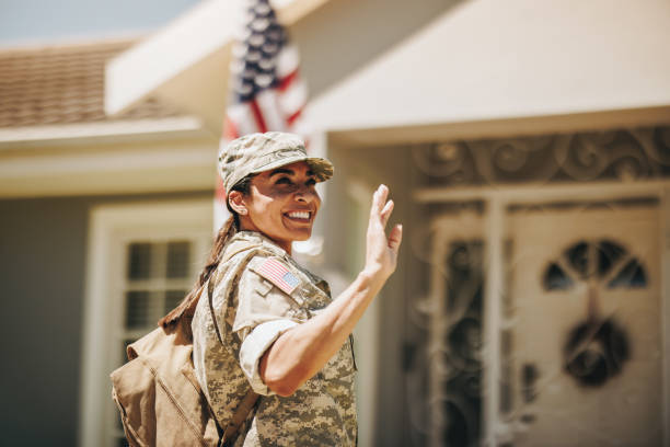 istock Happy servicewoman waving her hand on her homecoming 1400063889